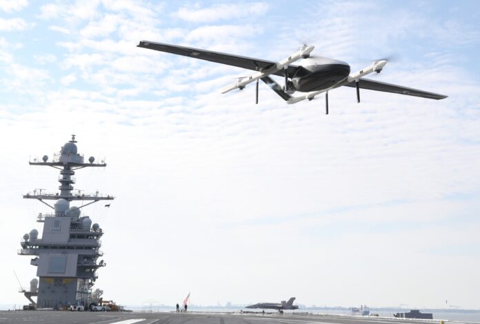 A logistics Unmanned Air System (UAS) prototype, called Blue Water UAS, approaches to deliver cargo on USS Gerald R. Ford’s (CVN 78) flight deck during supply demonstration Feb. 21, 2021. The test was successfully conducted by transporting light-weight logistical equipment from one part of Naval Station Norfolk aboard Ford while the aircraft carrier was in port. (U.S. Navy photo)