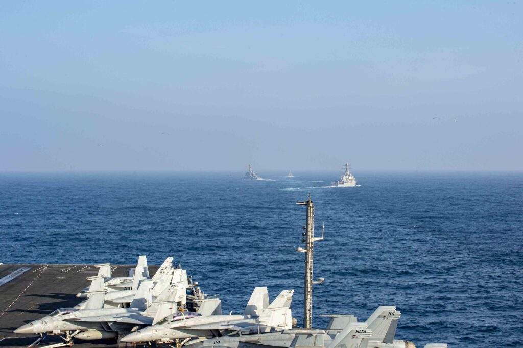 the arleigh burke-class destroyer uss porter (ddg-78), left, the royal moroccan navy frigate tarnk ben ziyad, center, and the arleigh burke-class destroyer uss mitscher (ddg-57), sail in formation with the nimitz-class aircraft carrier uss dwight d. eisenhower (cvn 69). ike is on a routine deployment in the u.s. sixth fleet area of operations in support of u.s. national interests and security in europe and africa. (u.s. navy photo)