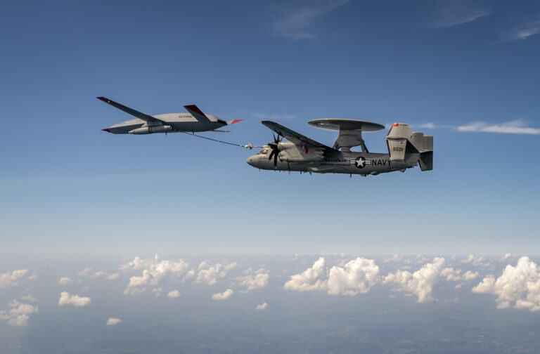 An MQ-25 Stingray unmanned aerial vehicle refuels an E-2D Advanced Hawkeye aircraft over MidAmerica Airport in Mascoutah, Ill,, Aug. 18, 2021.